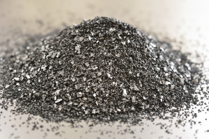 Heap of activated charcoal on a steel background